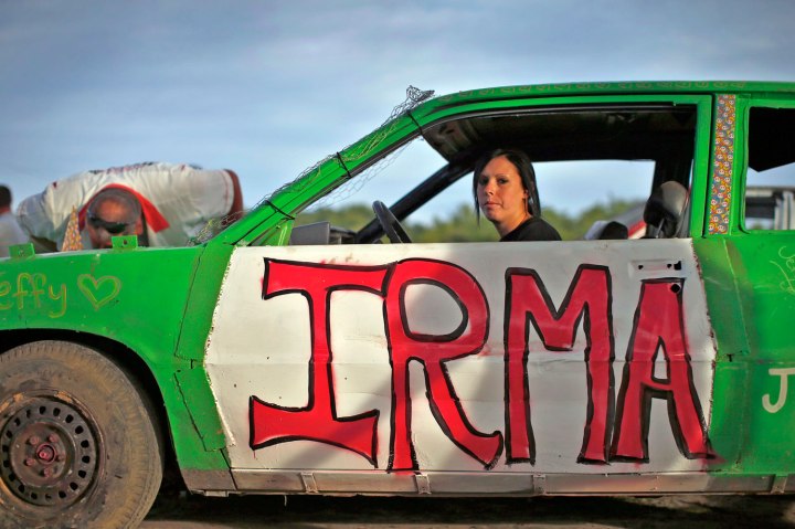 Jessica Riddle from Vernon, N.J., as her car "Irma" is inspected prior to competition in the Nation-Wide Demolition Derby in Augusta, N.J., on Aug. 4, 2013. 