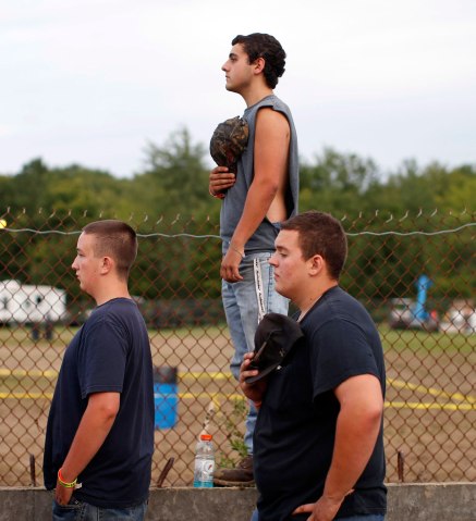 Boys stand during the playing of the U.S. National Anthem before competition in the Nation-Wide Demolition Derby in Augusta, N.J., on Aug. 4, 2013.