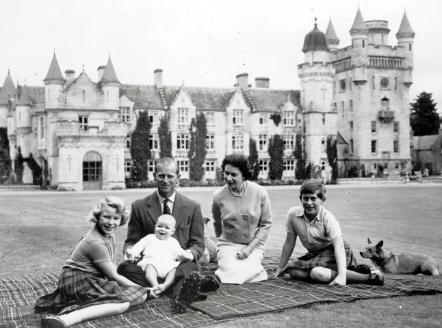 The Royal family during their holiday at the Balmoral Castle estate, Prince Andrew held on his father the Duke of Edinburgh's lap, Queen Elizabeth II with Princess Anne and Prince Charles and their Corgi dogs, Sept. 9, 1960.