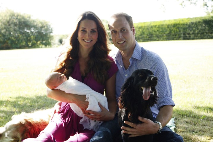 Prince William, Duke of Cambridge, his wife Catherine, Duchess of Cambridge, with their newborn baby boy, Prince George of Cambridge, Tilly the retriever, left, a Middleton family pet and Lupo, the couple's cocker spaniel, right, at the Middleton family home in Bucklebury, Berkshire, in early August, 2013. 