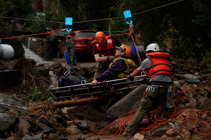 Darian Shaw of Salina being rescued by the Alpine Rescue Team using a high line and a sling across 4 Mile Canyon, she was brought across the rushing water with 3 other neighbors. The Alpine Rescue Team, 4 Mile Fire and the Rocky Mountain Rescue Team worked to get people out after heavy rains caused flash flooding and washed away most of Salina in 4 Mile Canyon Sept. 13, 2013.