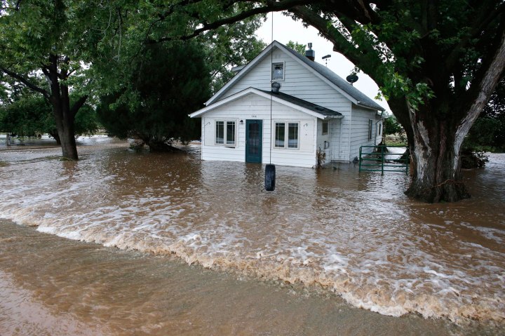Water flows through an evacuated neighborhood after days of flooding in Hygeine, Colo., on Sept. 15, 2013. 