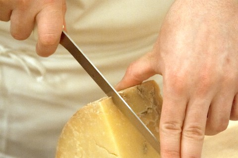 Man cutting fine cheese