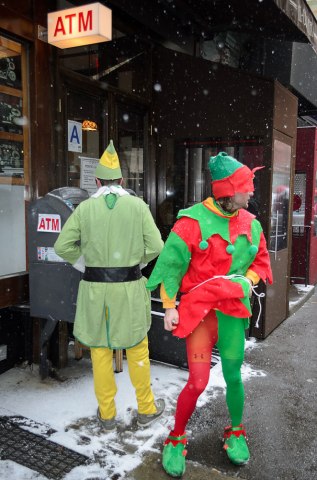 SantaCon revelers use an ATM in the East Village.