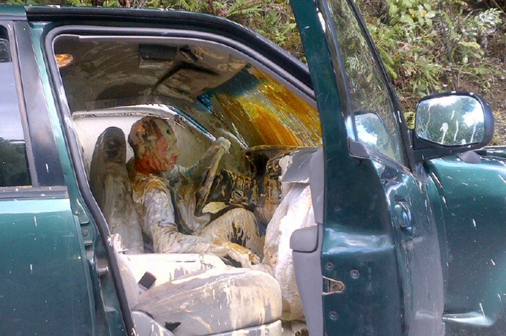 A motorist hauling buckets of paint is covered in paint after losing control of his SUV and went off the road in Belfair, Washington