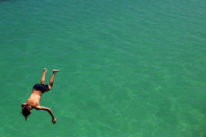 A teenager jumps from the jetty during a heat wave at Glenelg beach on Jan. 13, 2014 in Adelaide, Australia.