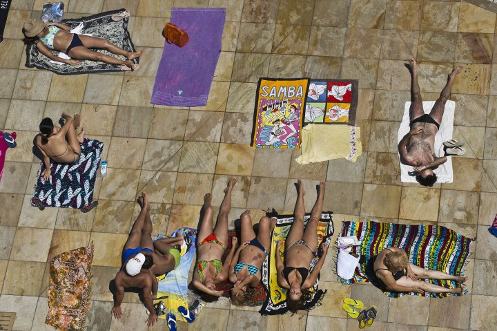 People are seen lounging poolside at the SESC Belenzinho club in Sao Paulo, Brazil on Jan. 31, 2014. 