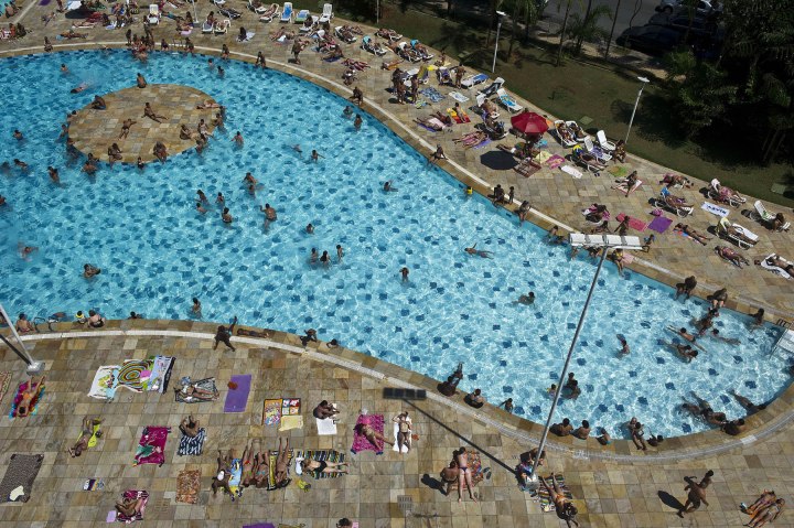 People lounge and swim at the SESC Belenzinho club in Sao Paulo, Brazil on Jan. 31, 2014. 