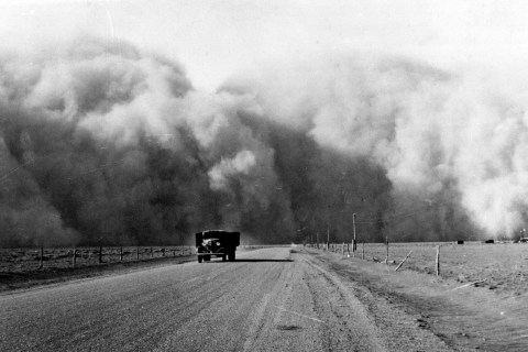 South of Lamar, Colo., a large dust cloud appears behind a truck traveling on highway 59, in May 1936.
